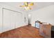 A bedroom featuring a ceiling fan, hardwood floors, and a closet at 6389 Grafton Dr, Austell, GA 30168