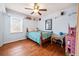 A bedroom featuring hardwood floors, a ceiling fan, and shelves at 6389 Grafton Dr, Austell, GA 30168
