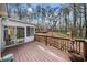 Wide wooden deck overlooking wooded backyard and adjacent sunroom at 6389 Grafton Dr, Austell, GA 30168