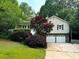 Charming home featuring stone accents, an attached two-car garage, and a well-maintained front lawn at 6389 Grafton Dr, Austell, GA 30168