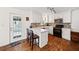 Bright kitchen with wooden floors, island, breakfast bar, stainless steel appliances, and white cabinetry at 6389 Grafton Dr, Austell, GA 30168