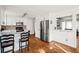 A kitchen featuring stainless steel appliances, white cabinetry, and a pass-through window to another room at 6389 Grafton Dr, Austell, GA 30168