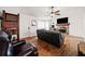 Cozy living room featuring a stone fireplace, hardwood floors, and a comfortable sitting area at 6389 Grafton Dr, Austell, GA 30168