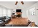 Spacious living room featuring hardwood floors, a stone fireplace, and ample natural light at 6389 Grafton Dr, Austell, GA 30168