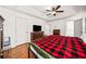 A spacious bedroom featuring a ceiling fan, hardwood floors, and a closet at 6389 Grafton Dr, Austell, GA 30168