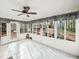 Bright sunroom featuring tile floors, multiple windows, and a ceiling fan at 6389 Grafton Dr, Austell, GA 30168