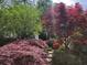 Lush backyard landscaping featuring various shrubs and colorful foliage at 6389 Grafton Dr, Austell, GA 30168