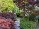 Landscaped yard with foliage, stone stairs and pathway to the home at 6389 Grafton Dr, Austell, GA 30168