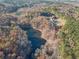 Aerial view of property highlighting pond and wooded area at 686 Newton Factory Bridge Rd, Covington, GA 30014