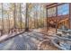 Brick patio with fountain and deck next to house, surrounded by colorful autumn trees at 686 Newton Factory Bridge Rd, Covington, GA 30014