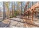 Spacious patio with wooden deck and pergola overlooking a wooded area at 686 Newton Factory Bridge Rd, Covington, GA 30014