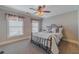 Bright bedroom with a ceiling fan and carpeted floors at 686 Newton Factory Bridge Rd, Covington, GA 30014