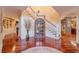 Grand foyer with hardwood floors and curved staircase at 686 Newton Factory Bridge Rd, Covington, GA 30014