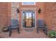 Front entry with brick porch and rocking chairs at 686 Newton Factory Bridge Rd, Covington, GA 30014