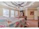 Main bedroom with tray ceiling, carpet flooring, and large windows at 686 Newton Factory Bridge Rd, Covington, GA 30014