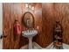 Powder room with pedestal sink, decorative wallcovering, and shelving at 686 Newton Factory Bridge Rd, Covington, GA 30014