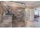 Large walk-in shower with multi-textured tile and glass enclosure at 686 Newton Factory Bridge Rd, Covington, GA 30014