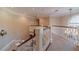 Elegant upstairs hallway with hardwood floors, white railings, and chandelier at 686 Newton Factory Bridge Rd, Covington, GA 30014