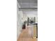 Bright hallway with hardwood floors and view of living area at 800 Peachtree St # 1112, Atlanta, GA 30308