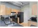 Modern kitchen with light wood cabinets and black appliances at 800 Peachtree St # 1112, Atlanta, GA 30308