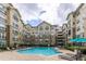 Community pool with lounge chairs and umbrellas at 800 Peachtree St # 1112, Atlanta, GA 30308