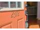 Orange front door with brass 2372 address at 2372 Johnson Rd, Atlanta, GA 30345