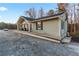 Ranch style home with gray siding, a covered entry, and a spacious front yard at 4955 R H Smith Blvd, Sugar Hill, GA 30518