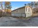 Tan house exterior with a gravel driveway and satellite dish at 4955 R H Smith Blvd, Sugar Hill, GA 30518