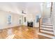 Spacious living room featuring hardwood floors, a fireplace, and a staircase at 683 Terry Se St, Atlanta, GA 30315