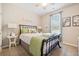 Cozy bedroom with a metal bed frame, green bedding, and a side table at 754 Somersby Dr, Dallas, GA 30157