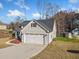 Craftsman style home with gray siding, two-car garage, and landscaped yard at 754 Somersby Dr, Dallas, GA 30157