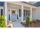 Inviting front porch with light blue door and charming landscaping at 754 Somersby Dr, Dallas, GA 30157