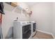 Convenient laundry room with washer, dryer, and overhead shelving for storage at 754 Somersby Dr, Dallas, GA 30157