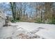 Large backyard with a snow-covered lawn and a patio at 459 Oak Se Dr, Atlanta, GA 30354