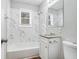 Updated bathroom with marble tile, shower/tub combo, and granite vanity at 459 Oak Se Dr, Atlanta, GA 30354