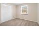 Simple carpeted bedroom with a closet and window with blinds at 459 Oak Se Dr, Atlanta, GA 30354