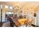 Sunlit dining room features a large table, chandelier, and wall art at 5274 Monarch Pine Ln, Peachtree Corners, GA 30071