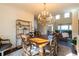 Elegant dining room with a chandelier, hardwood floors, and a large table at 5274 Monarch Pine Ln, Peachtree Corners, GA 30071