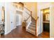 Hardwood floor entryway with staircase and powder room at 5274 Monarch Pine Ln, Peachtree Corners, GA 30071