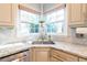 Kitchen corner sink with white herringbone backsplash and granite countertops at 5274 Monarch Pine Ln, Peachtree Corners, GA 30071