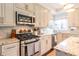 Modern kitchen featuring stainless steel appliances and light beige cabinetry at 5274 Monarch Pine Ln, Peachtree Corners, GA 30071