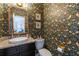 Small powder room with floral wallpaper and modern vanity at 5274 Monarch Pine Ln, Peachtree Corners, GA 30071