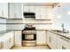 Updated kitchen with white cabinets, granite countertops and stainless steel appliances at 620 Peachtree Ne St # 415, Atlanta, GA 30308