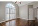 Bright bedroom with hardwood floors, arched window, and shutters at 6204 Woodlore Nw Dr, Acworth, GA 30101