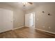 Well-lit bedroom featuring wood-look floors and multiple doors at 6204 Woodlore Nw Dr, Acworth, GA 30101