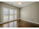 Bright bedroom with hardwood floors, plantation shutters, and ceiling fan at 6204 Woodlore Nw Dr, Acworth, GA 30101