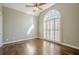 Bedroom with hardwood floors, arched window, and plantation shutters at 6204 Woodlore Nw Dr, Acworth, GA 30101