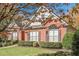 Red brick house with gray roof, shutters, and autumn leaves at 6204 Woodlore Nw Dr, Acworth, GA 30101