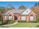 Brick house with gray roof, landscaping, and walkway at 6204 Woodlore Nw Dr, Acworth, GA 30101