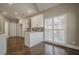 Eat-in kitchen boasts white cabinets, stainless steel appliances, and a view to backyard at 6204 Woodlore Nw Dr, Acworth, GA 30101